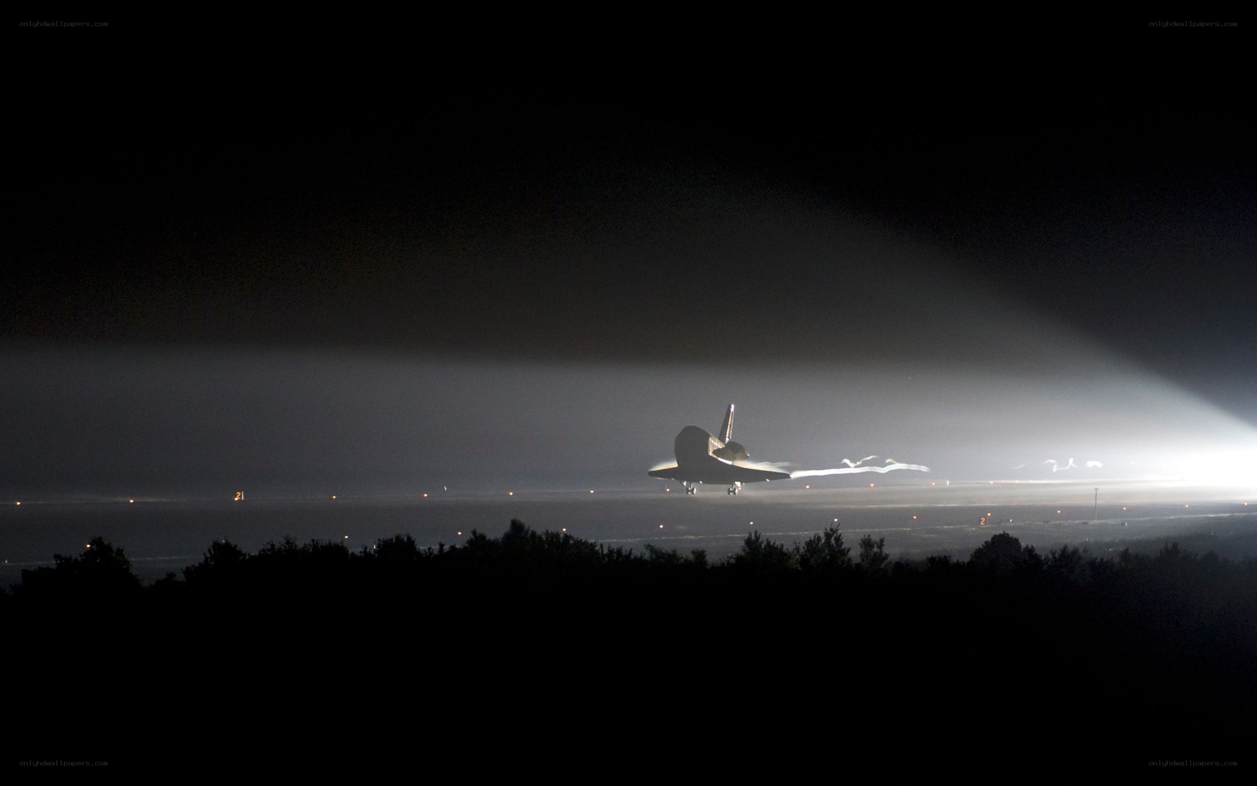 Space shuttle landing at night