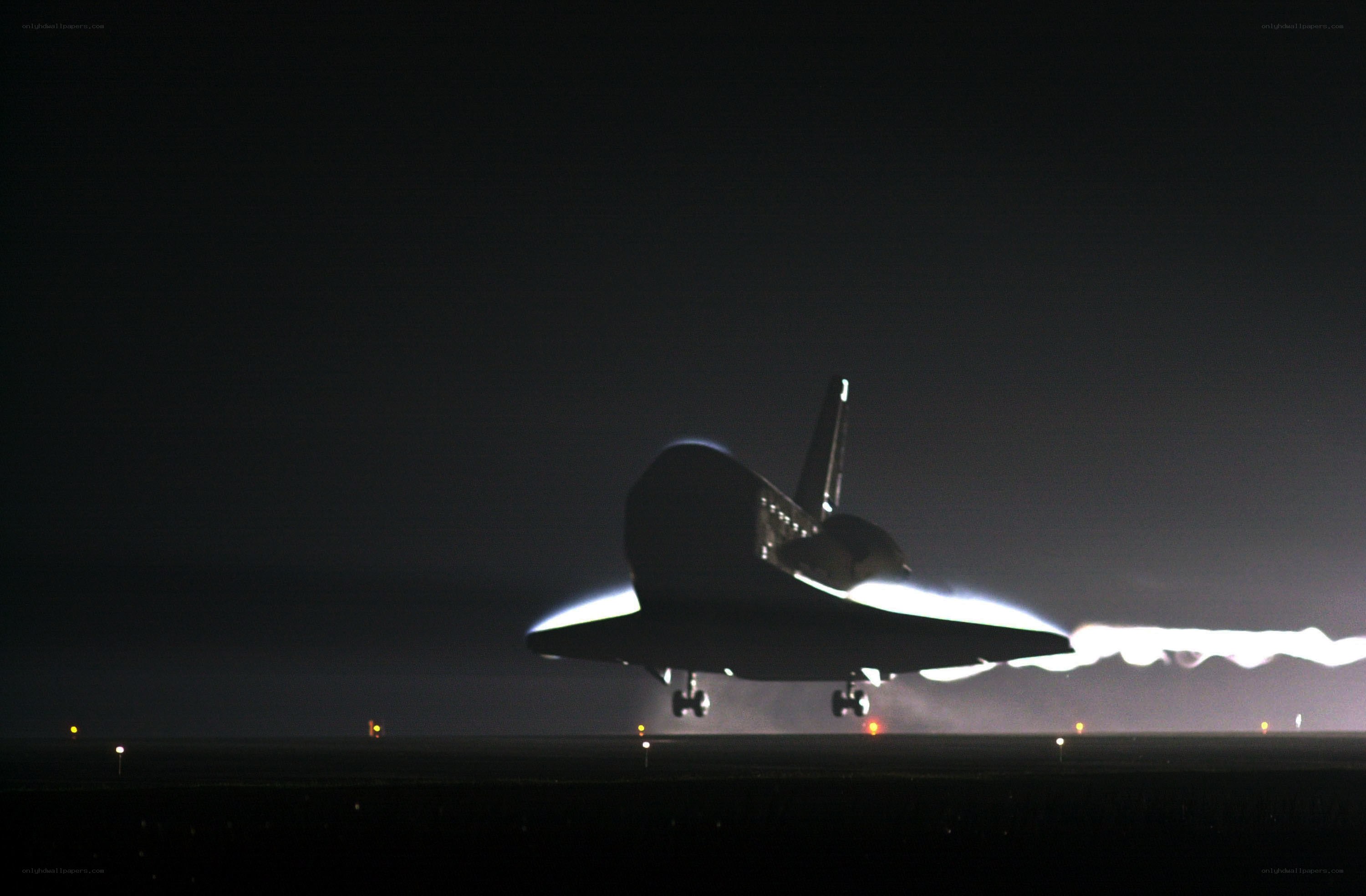 Space shuttle landing at night
