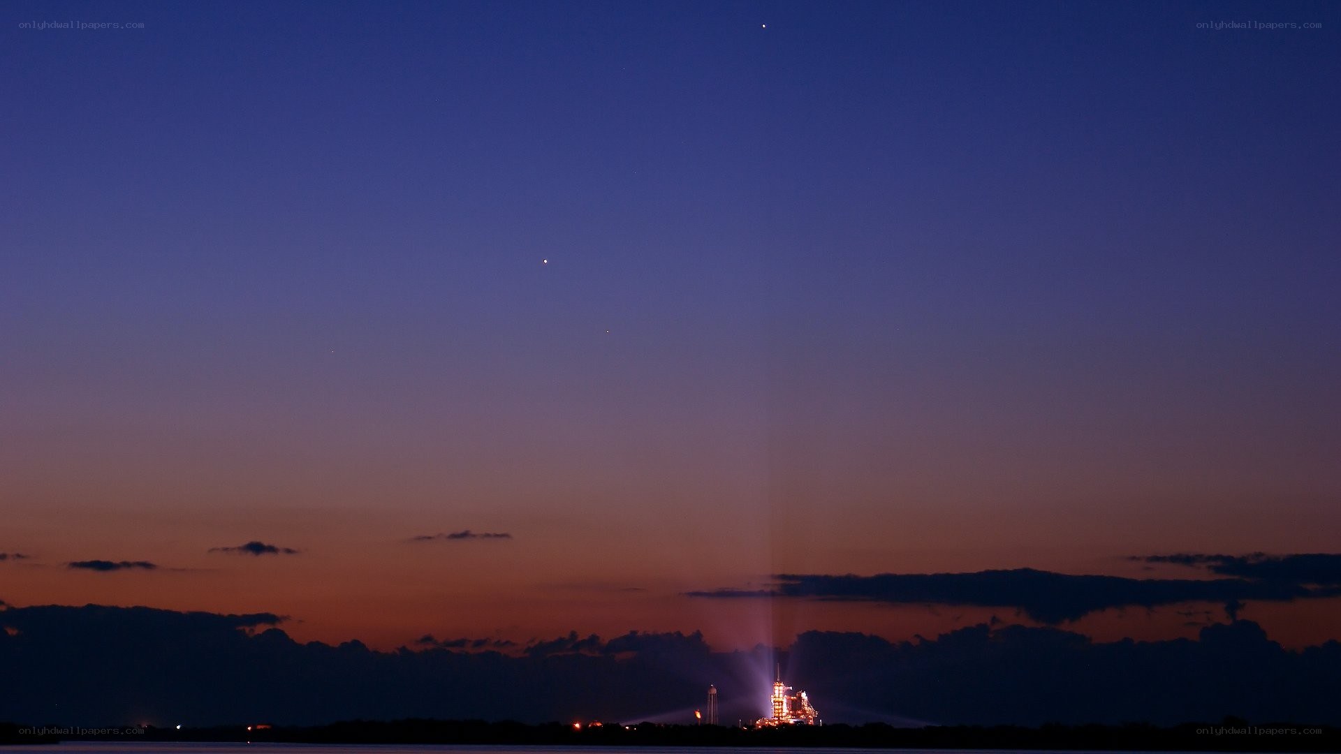 Space shuttle launch at dusk