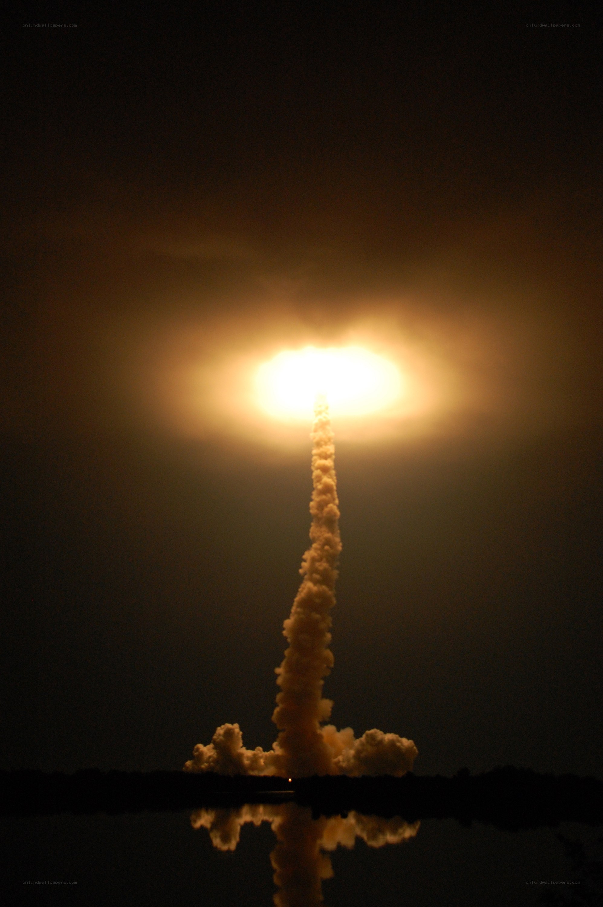 Space shuttle launch at night