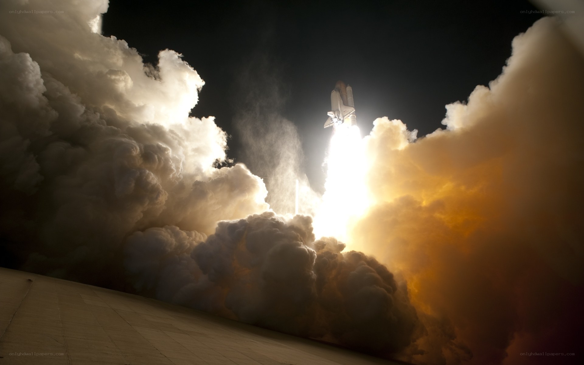 Space shuttle launch at night