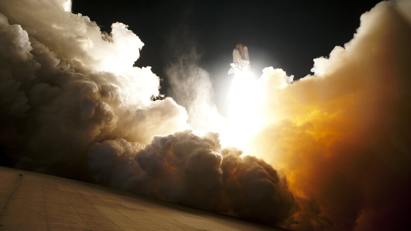 Space shuttle launch at night