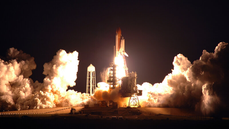 Space shuttle launch at night