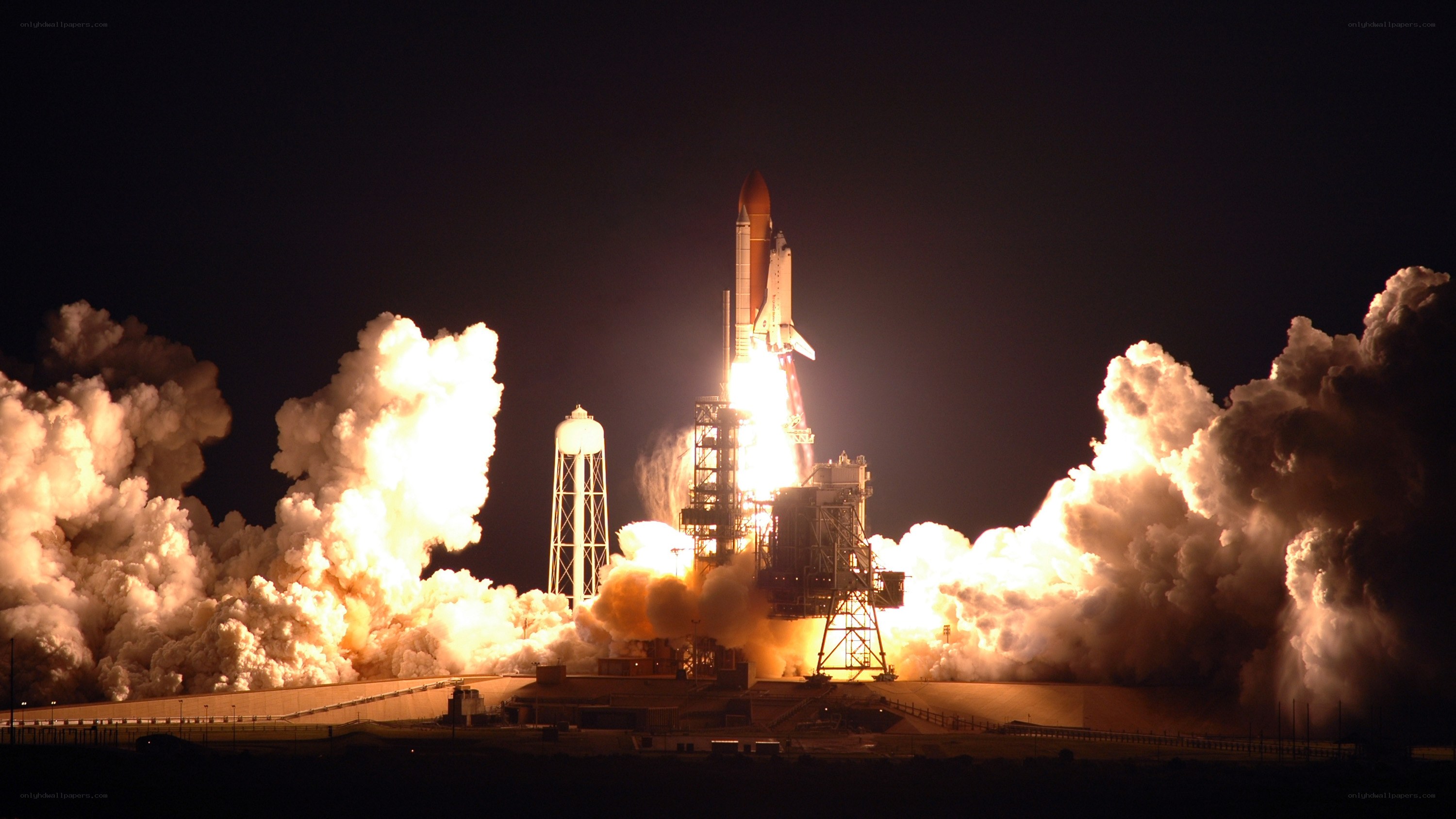 Space shuttle launch at night