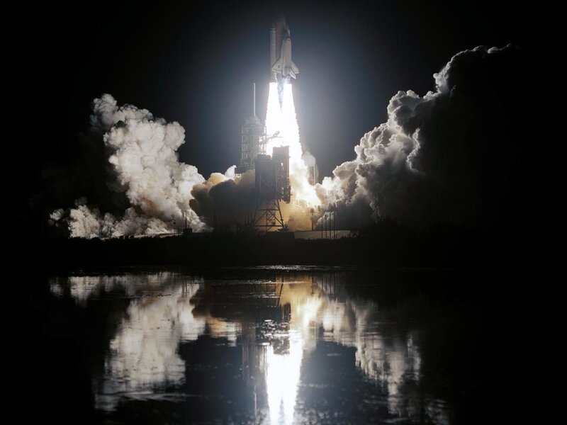 Space shuttle launch at night