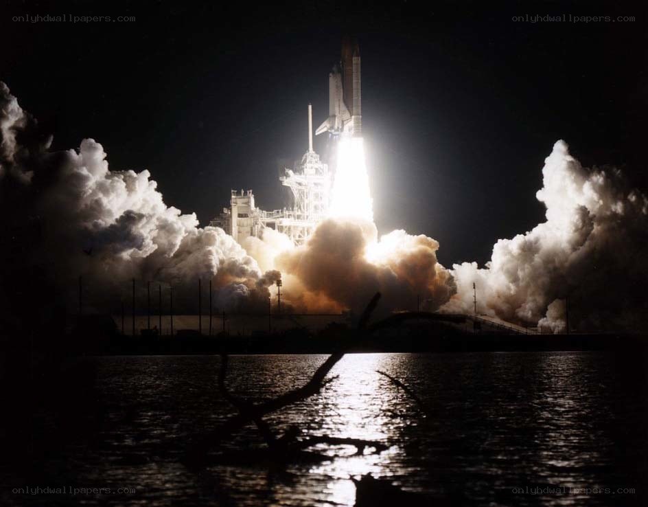 Space shuttle launch at night