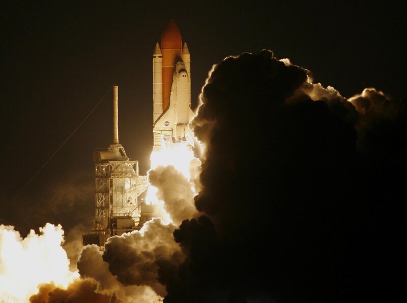 Space shuttle launch at night