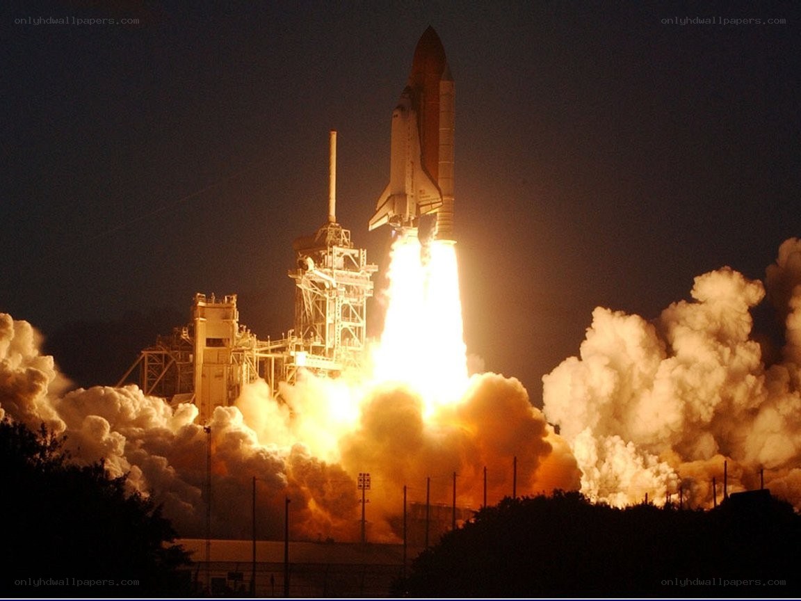 Space shuttle launch at night