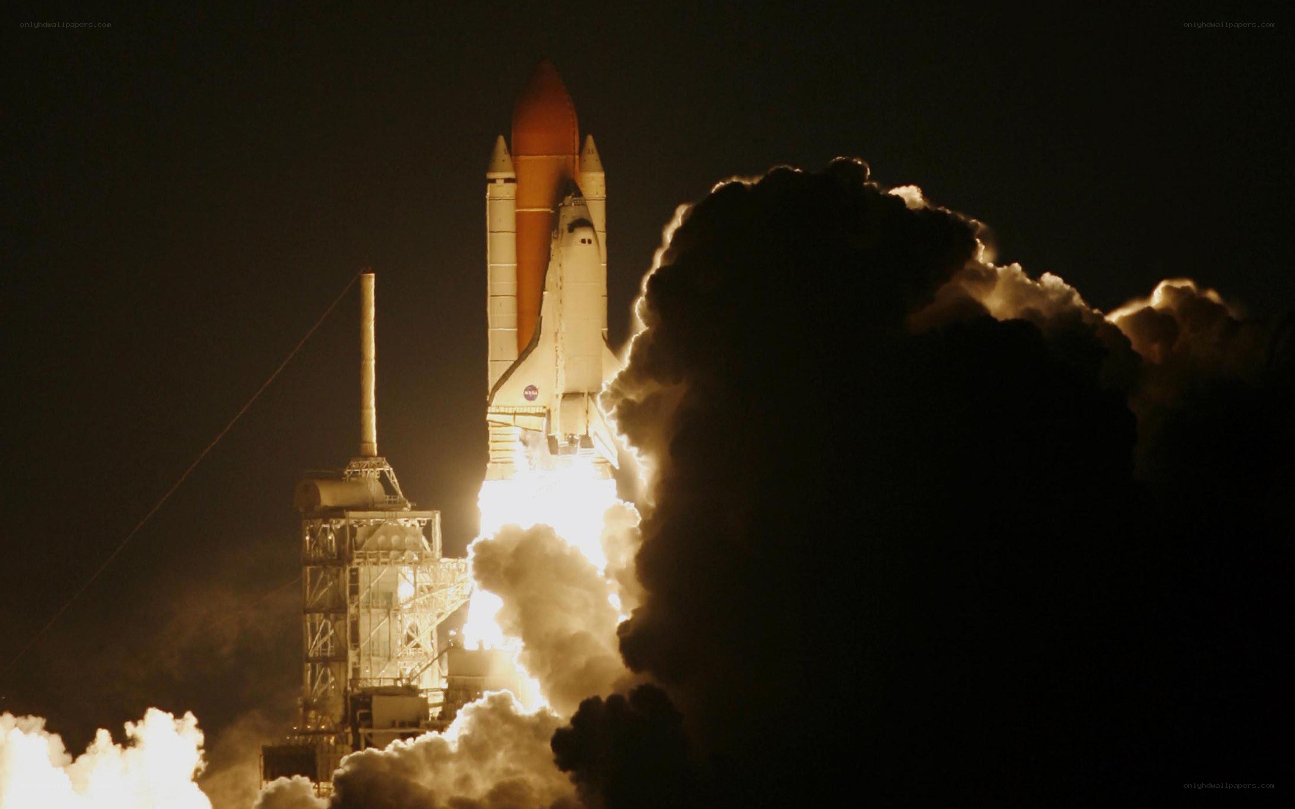 Space shuttle launch at night