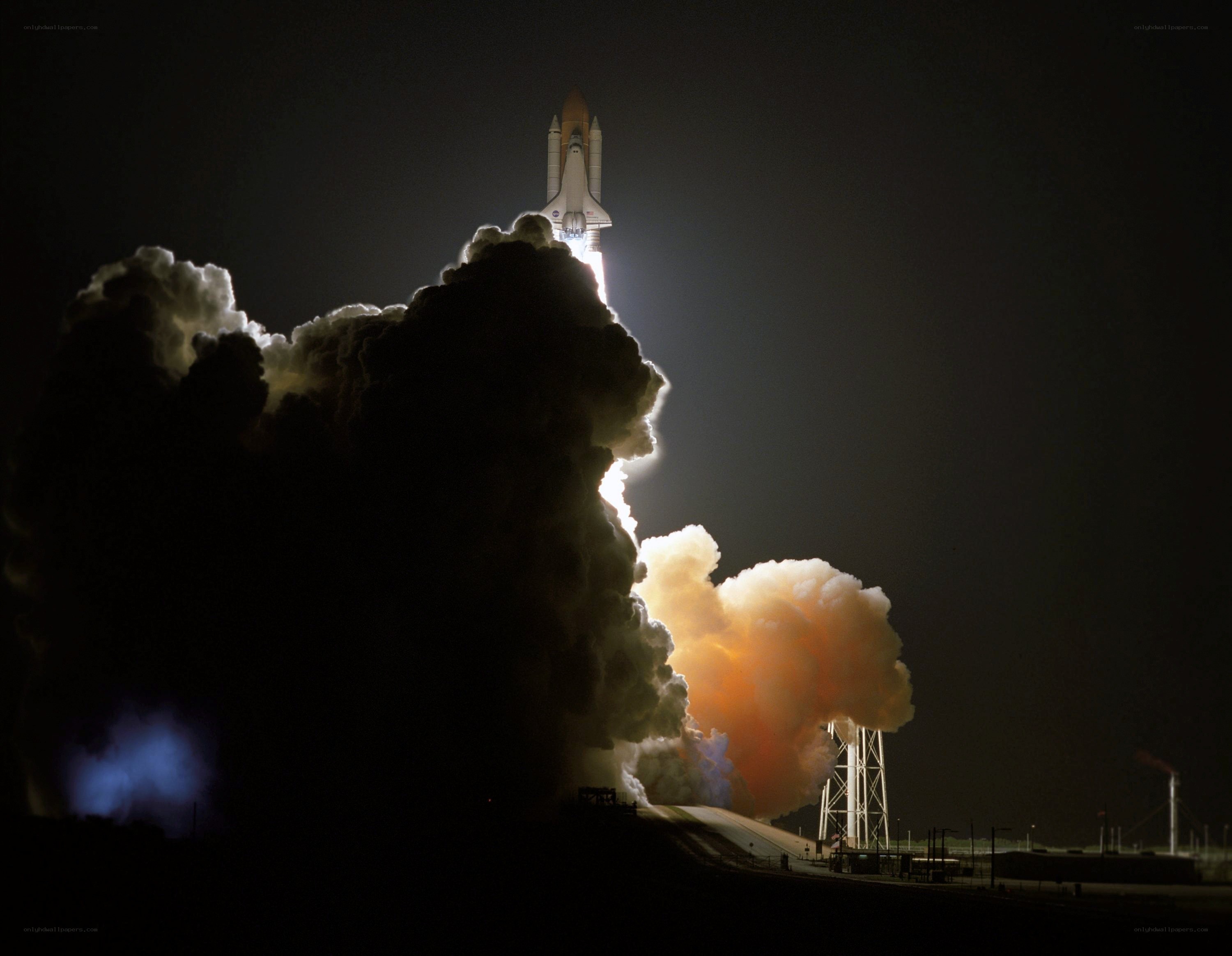 Space shuttle launch at night