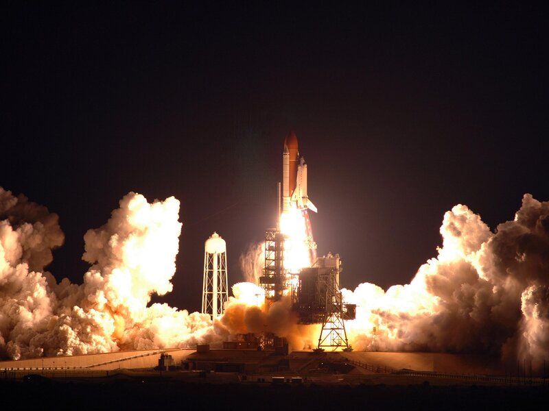 Space shuttle launch at night