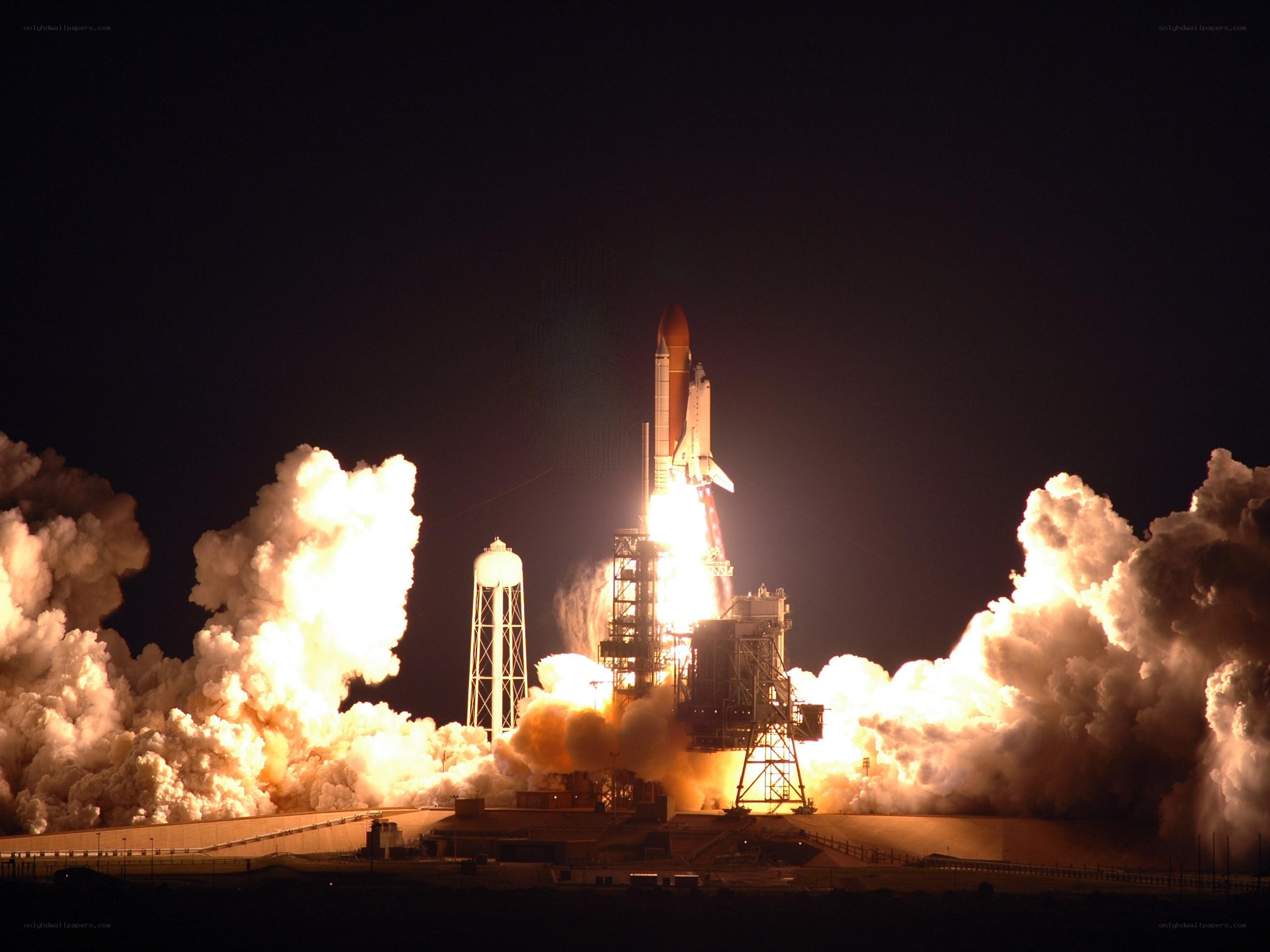Space shuttle launch at night