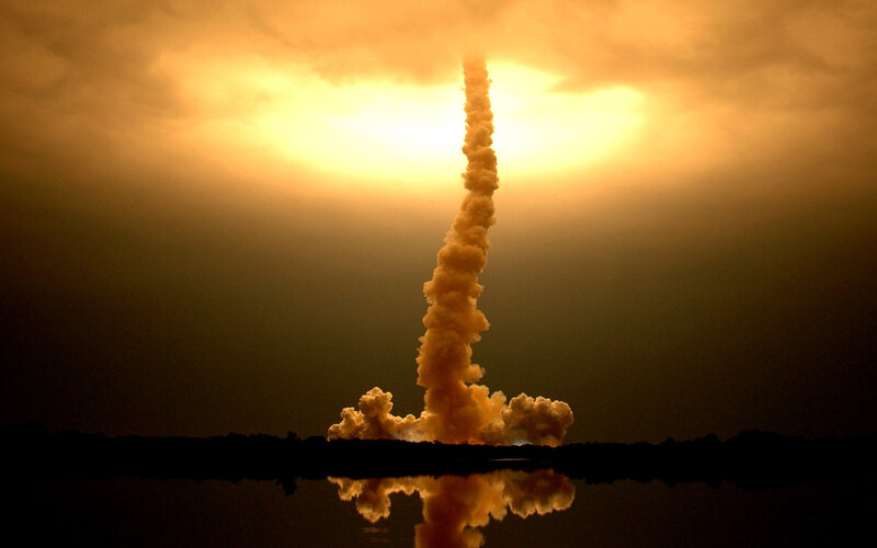 Space shuttle launch at sunset