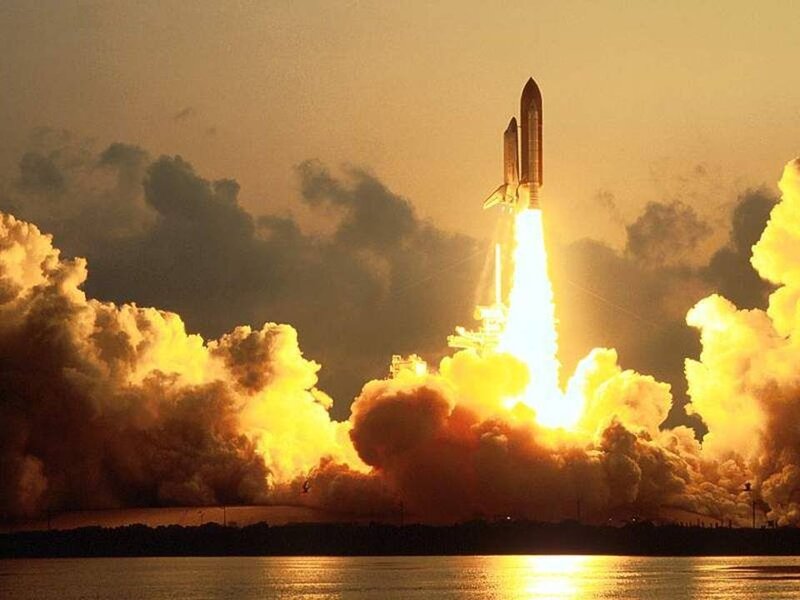 Space shuttle launch at sunset