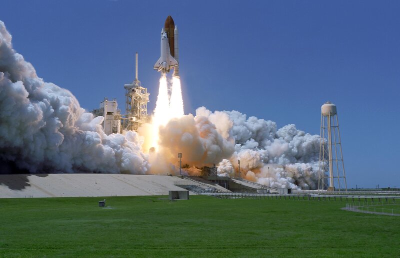 Space Shuttle Launch — Blue, Dramatic, Afternoon, Photograph, Rocket, Clouds, Water Tower, Grass