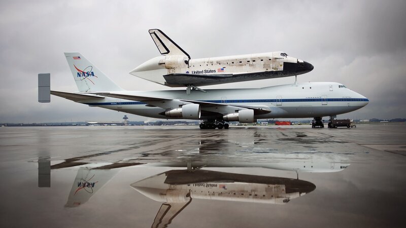 Space Shuttle on Airplane — Gray, Dramatic, Photograph, Runway, Reflection, White