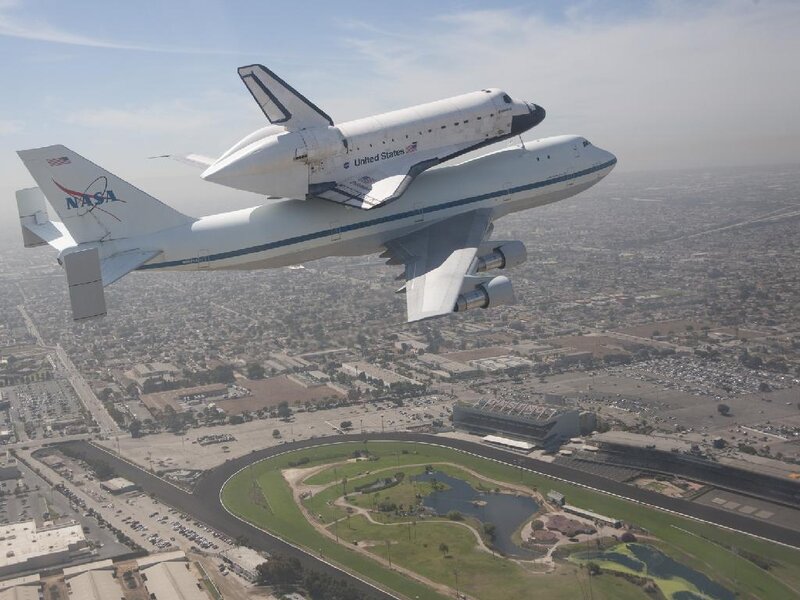 Space Shuttle on Airplane — White, Dramatic, Afternoon, Photograph, Cityscape, Runway