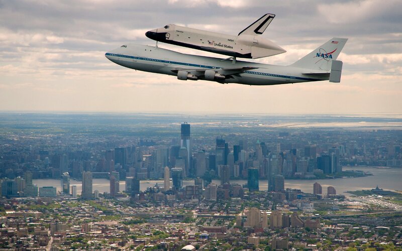 Space Shuttle on Airplane — White, Dramatic, Afternoon, Photograph, Cityscape, Sky
