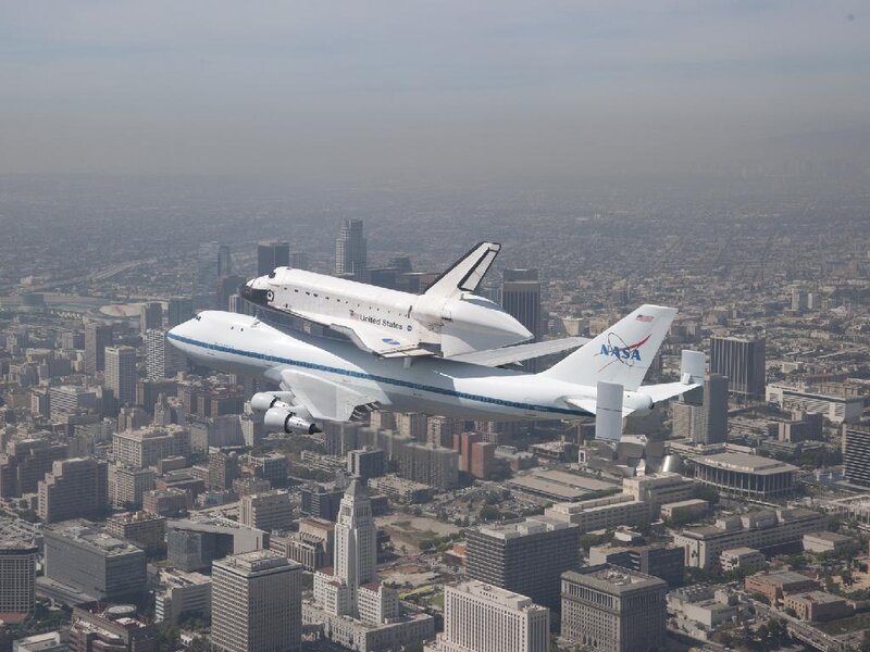 Space Shuttle on Airplane — White, Dramatic, Afternoon, Photograph, Cityscape