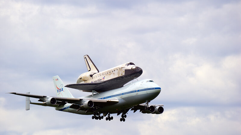 Space Shuttle on Airplane — White, Dramatic, Afternoon, Photograph, Clouds