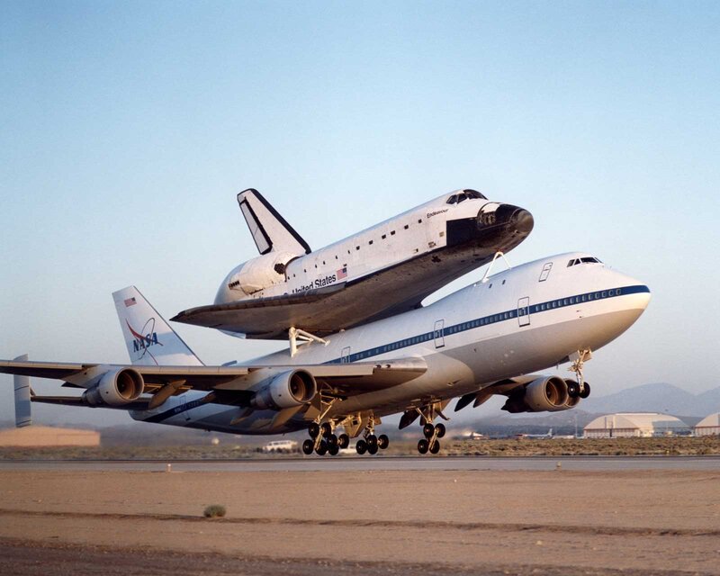 Space Shuttle on Airplane — White, Dramatic, Afternoon, Photograph, Runway