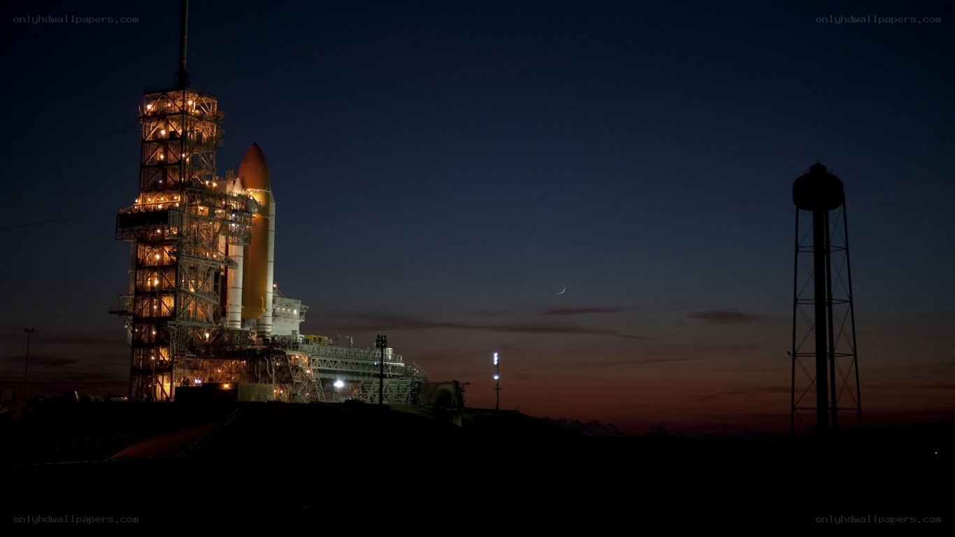 Space shuttle on launch pad at dusk
