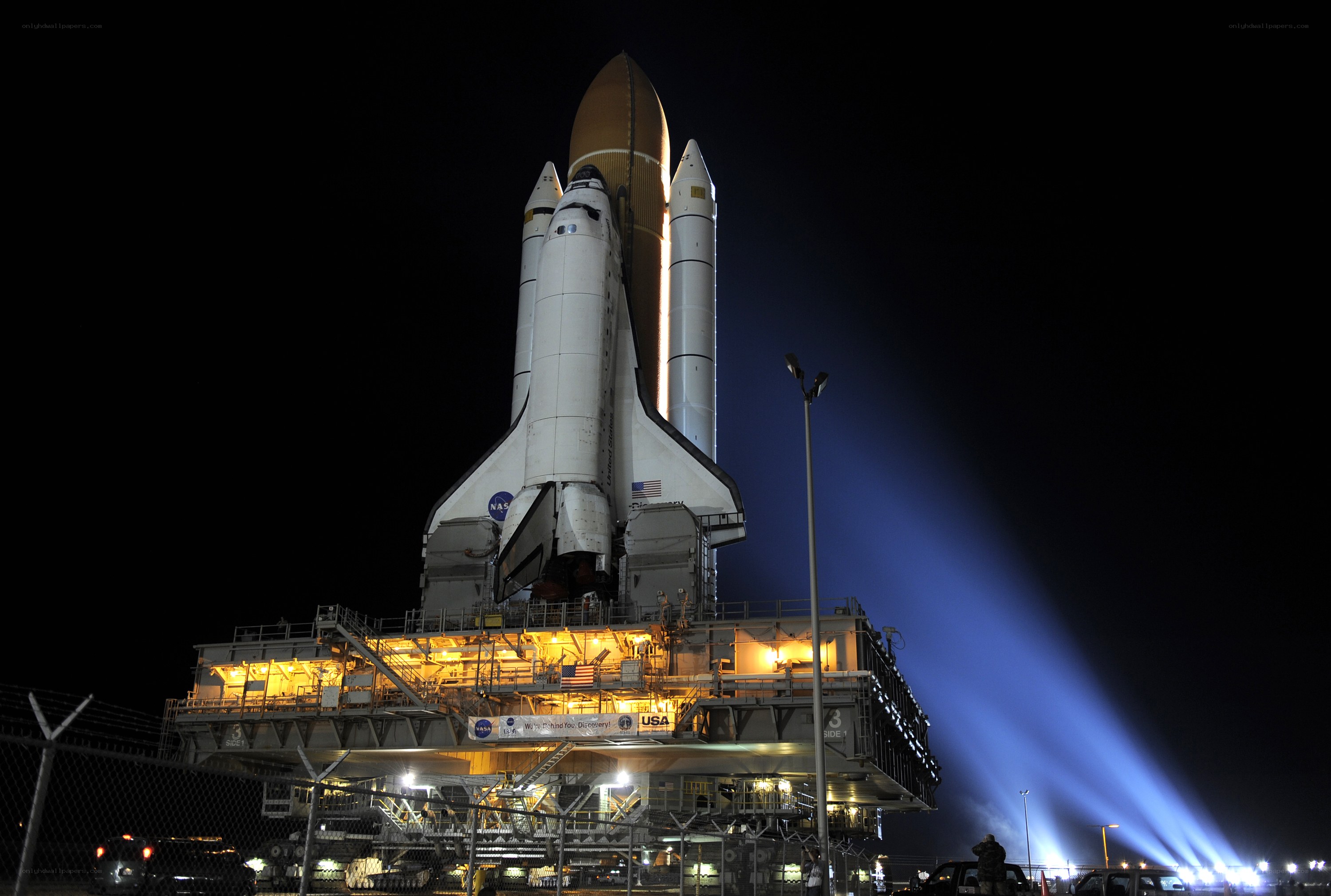 Space shuttle on launch pad at night