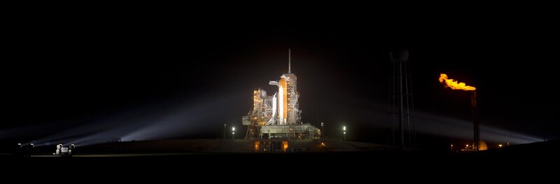 Space shuttle on launch pad at night