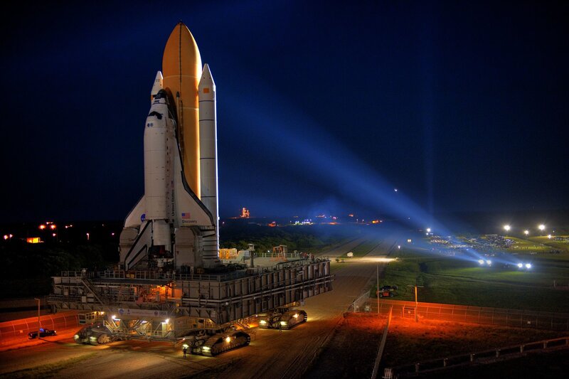 Space shuttle on launch pad at night