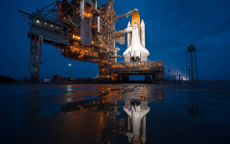 Space Shuttle on Launch Pad — Blue, Dramatic, Night, Photograph, Launch Tower, Water Tower, Puddle