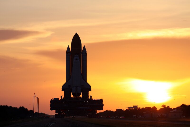 Space Shuttle on Transport — Orange, Dramatic, Sunset