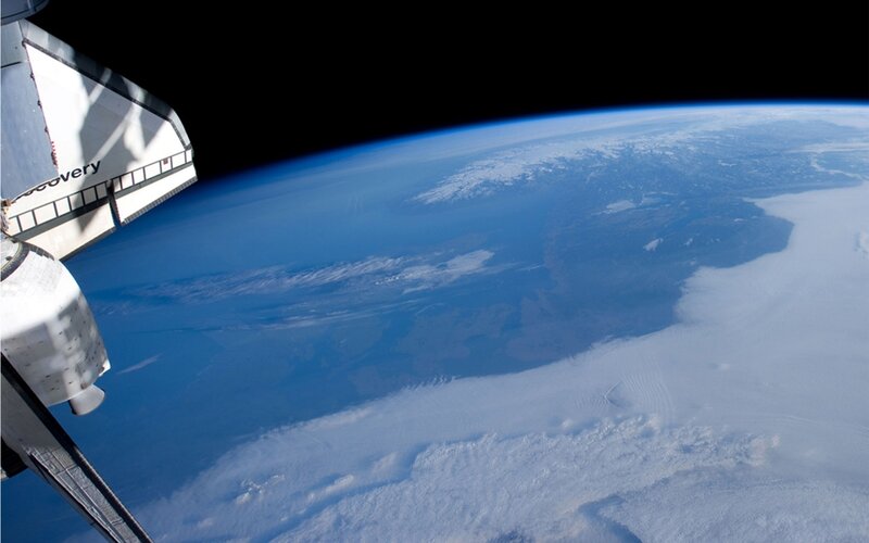 Space shuttle over Earth