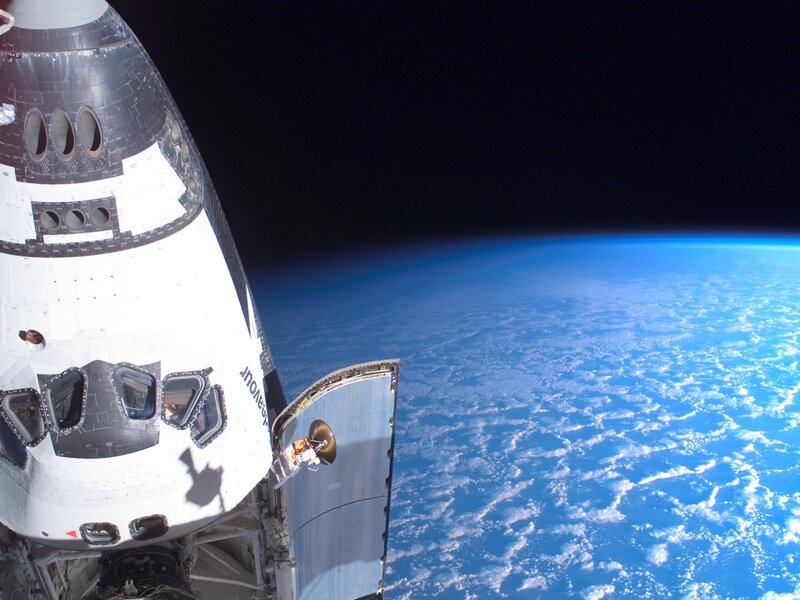 Space shuttle over Earth