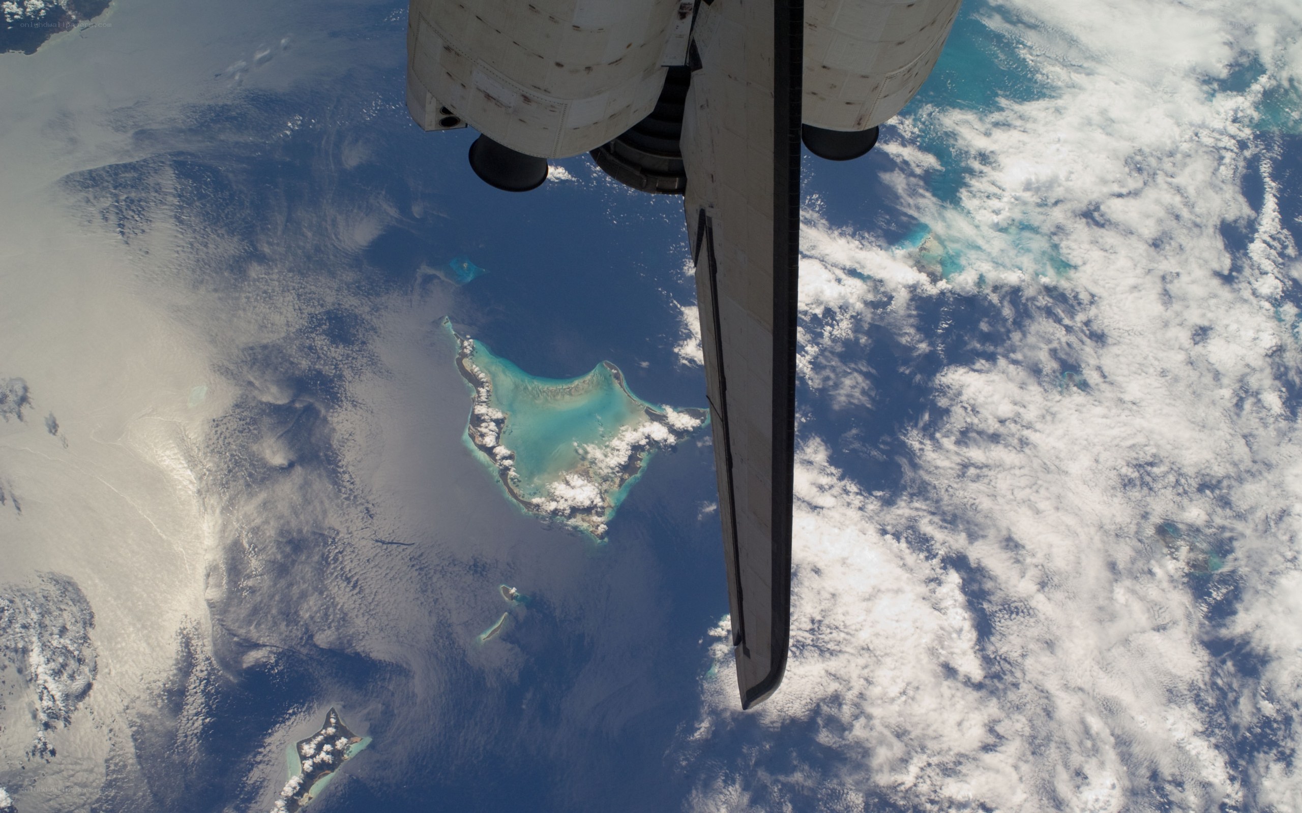 space shuttle over tropical island