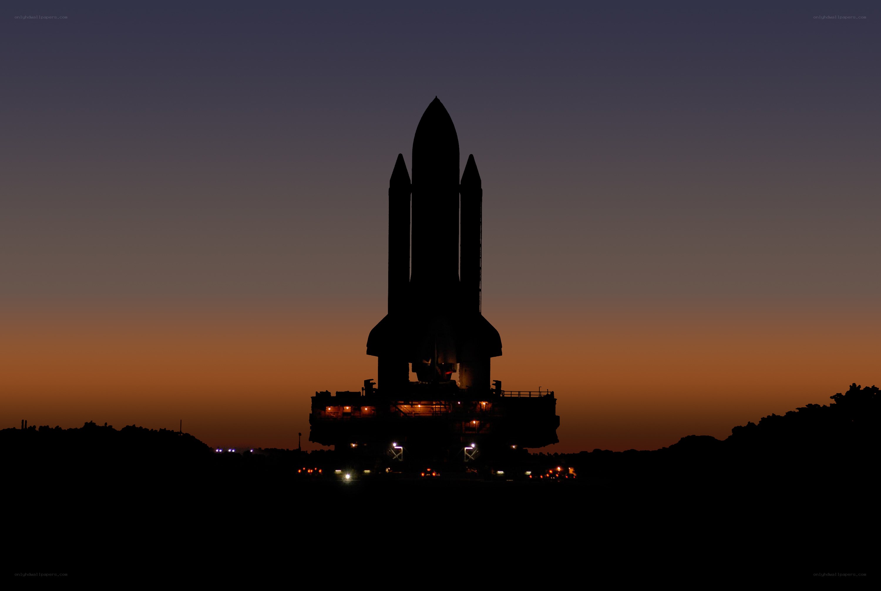 Space shuttle silhouette at dusk