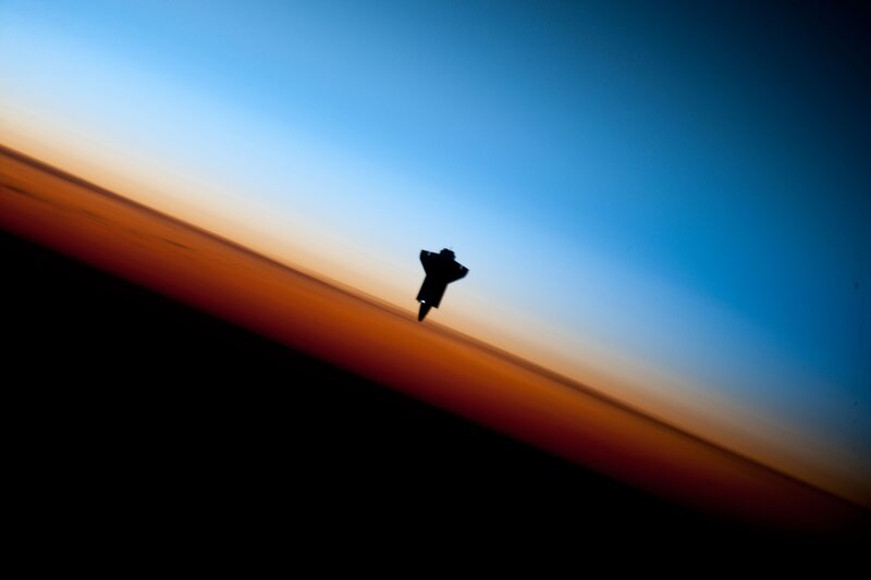 space shuttle silhouette at sunset