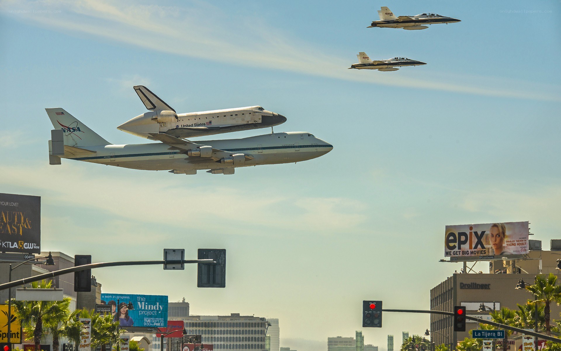 Space shuttle transport over city