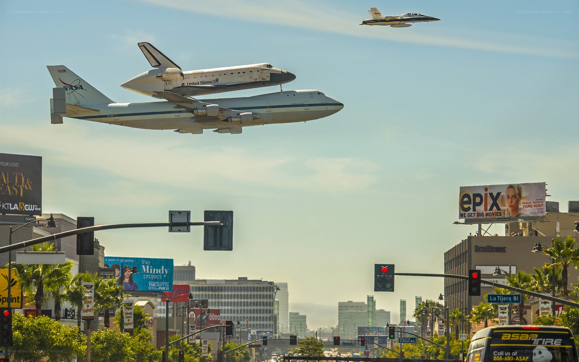Space shuttle transport over city