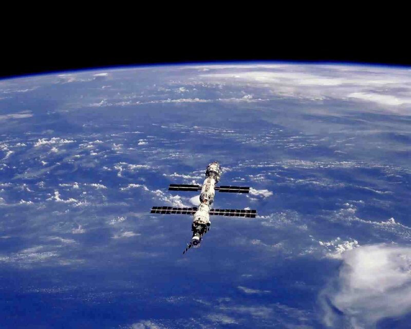 Space Station in Orbit — Blue, Serene, Photograph, Earth, Clouds, Solar Panels