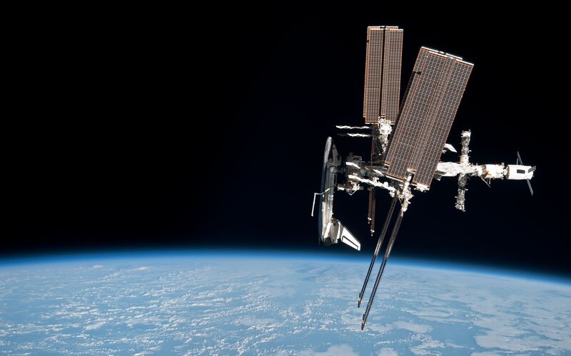 Space Station in Orbit — Blue, Serene, Photograph, Earth, Solar Panels, Spacecraft