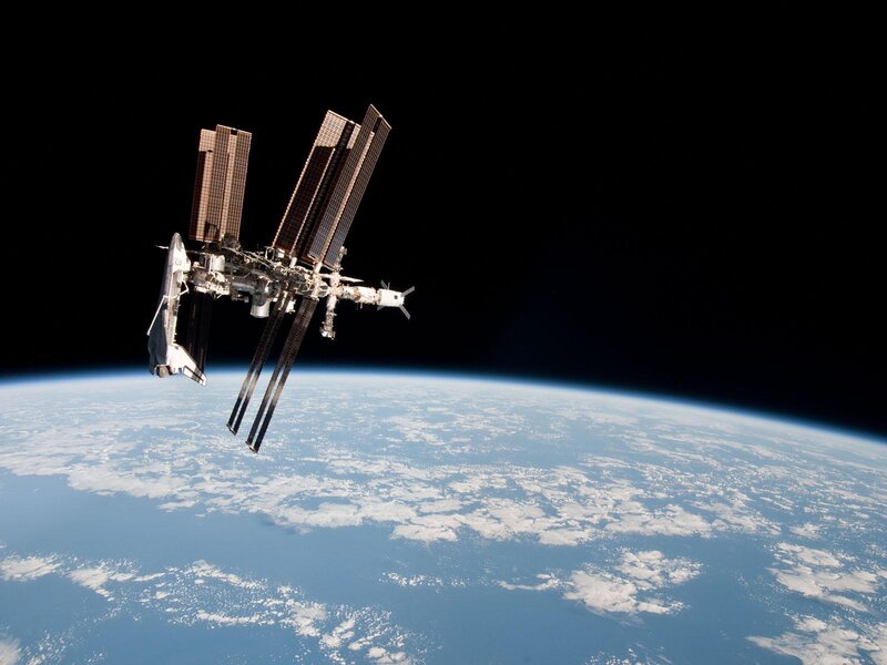 Space Station in Orbit — Blue, Serene, Photograph, Earth, Solar Panels, Spacecraft, White