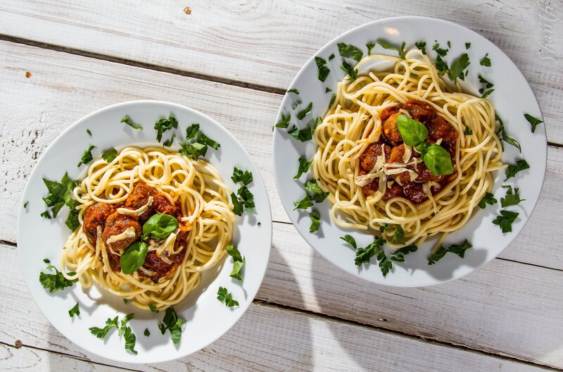 Spaghetti with meatballs on white plates