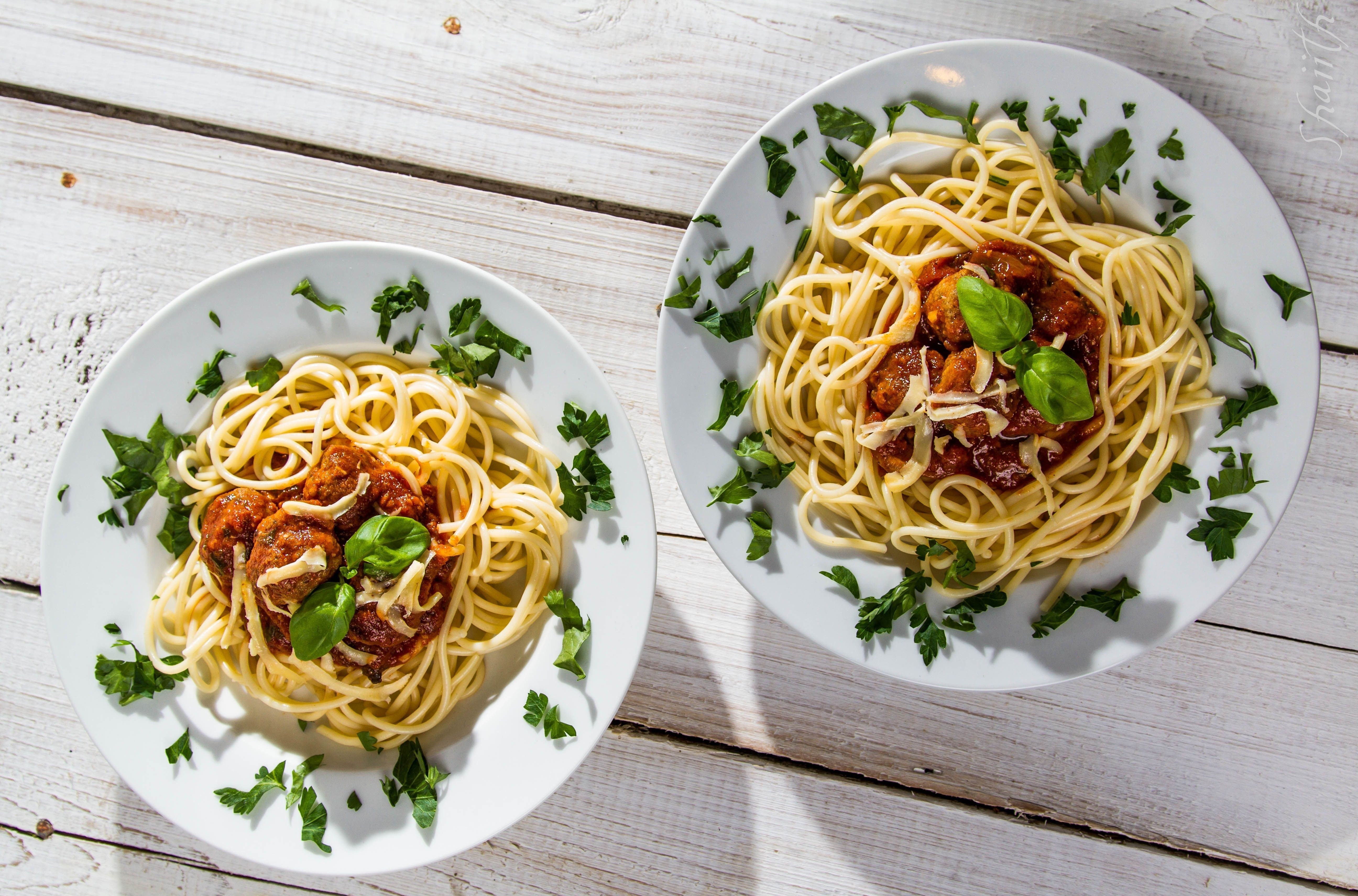Spaghetti with meatballs on white plates
