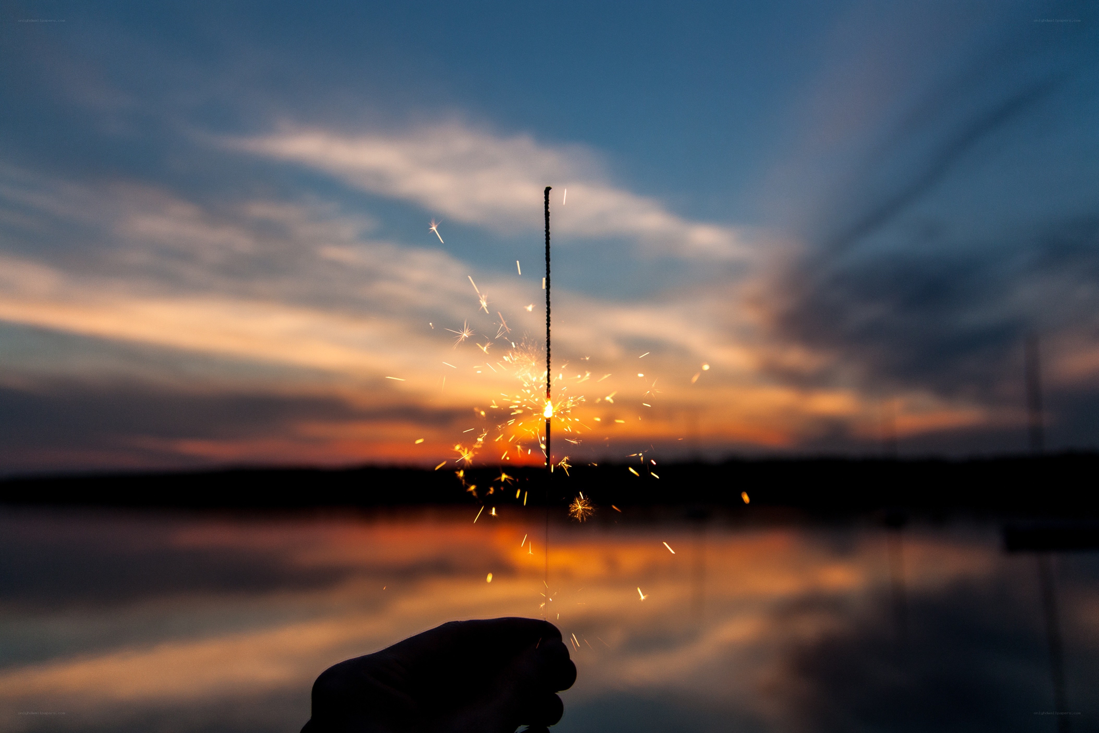 Sparkler at sunset by the water