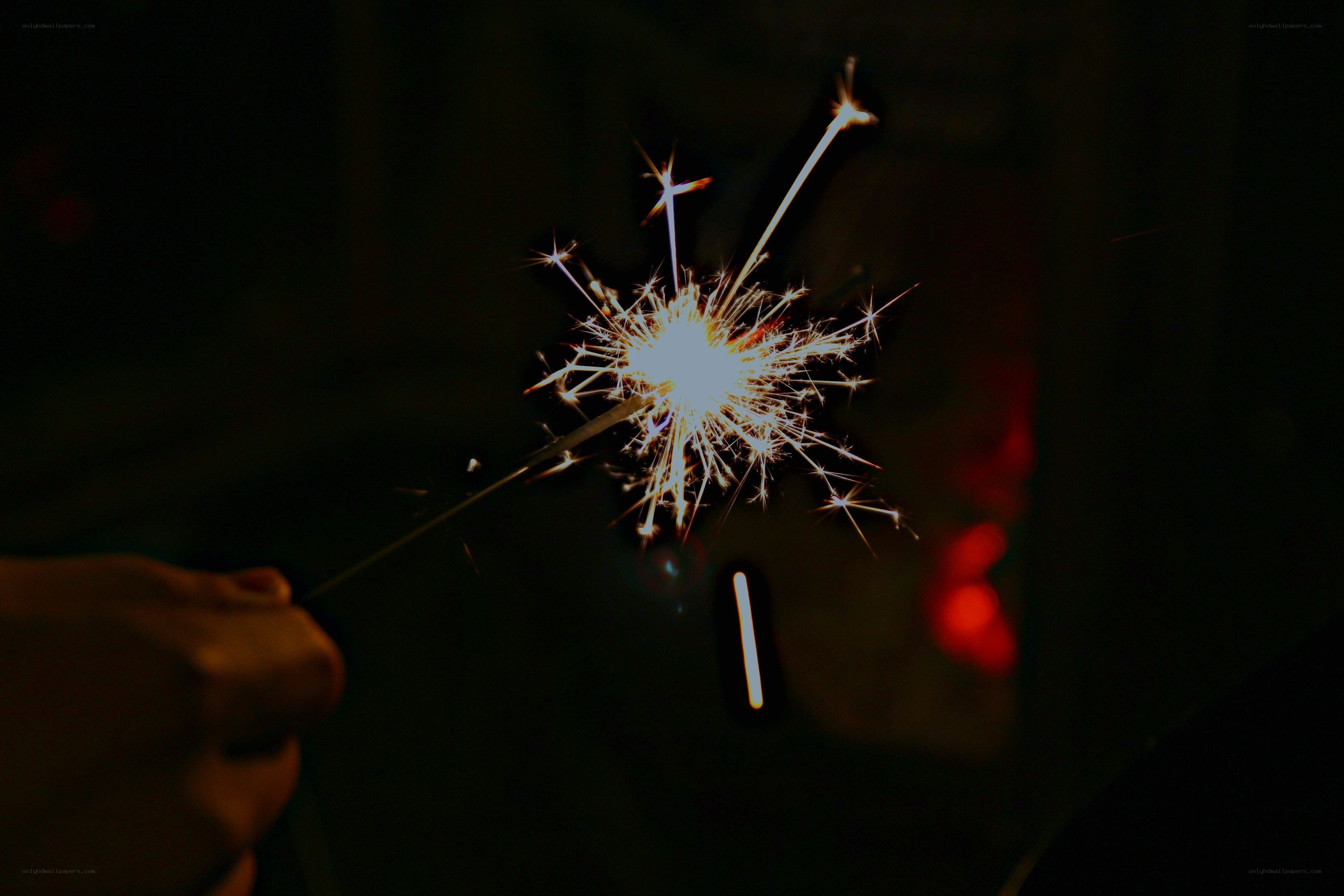 Sparkler in hand at night