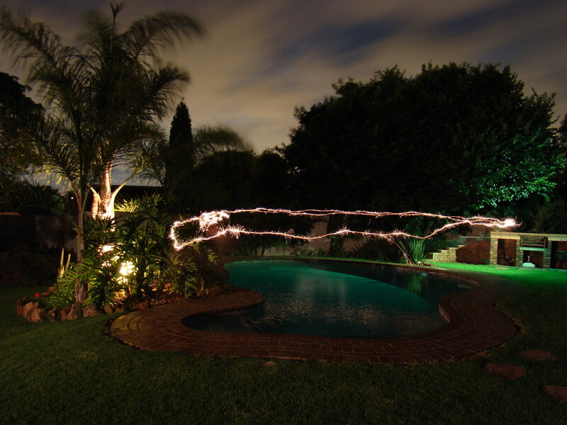 Sparkler over a pool at night