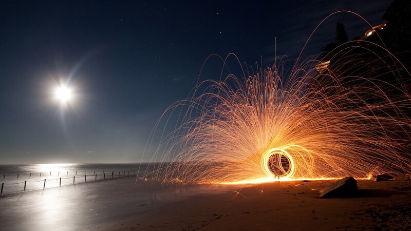 Sparks on Beach at Night