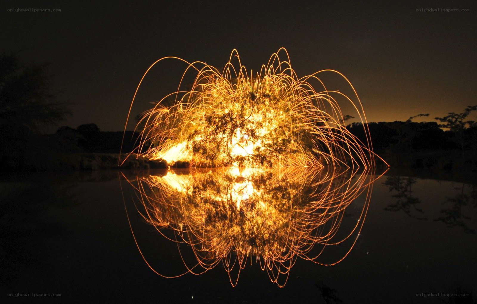 Sparks reflected in water