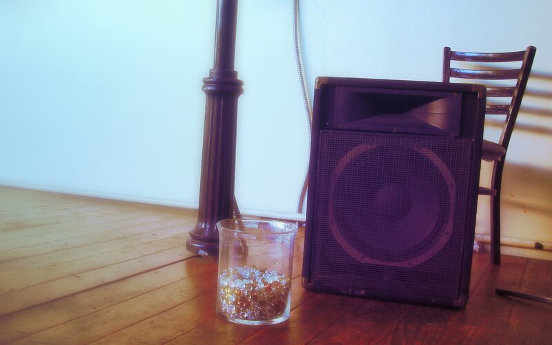 speaker and glass on floor