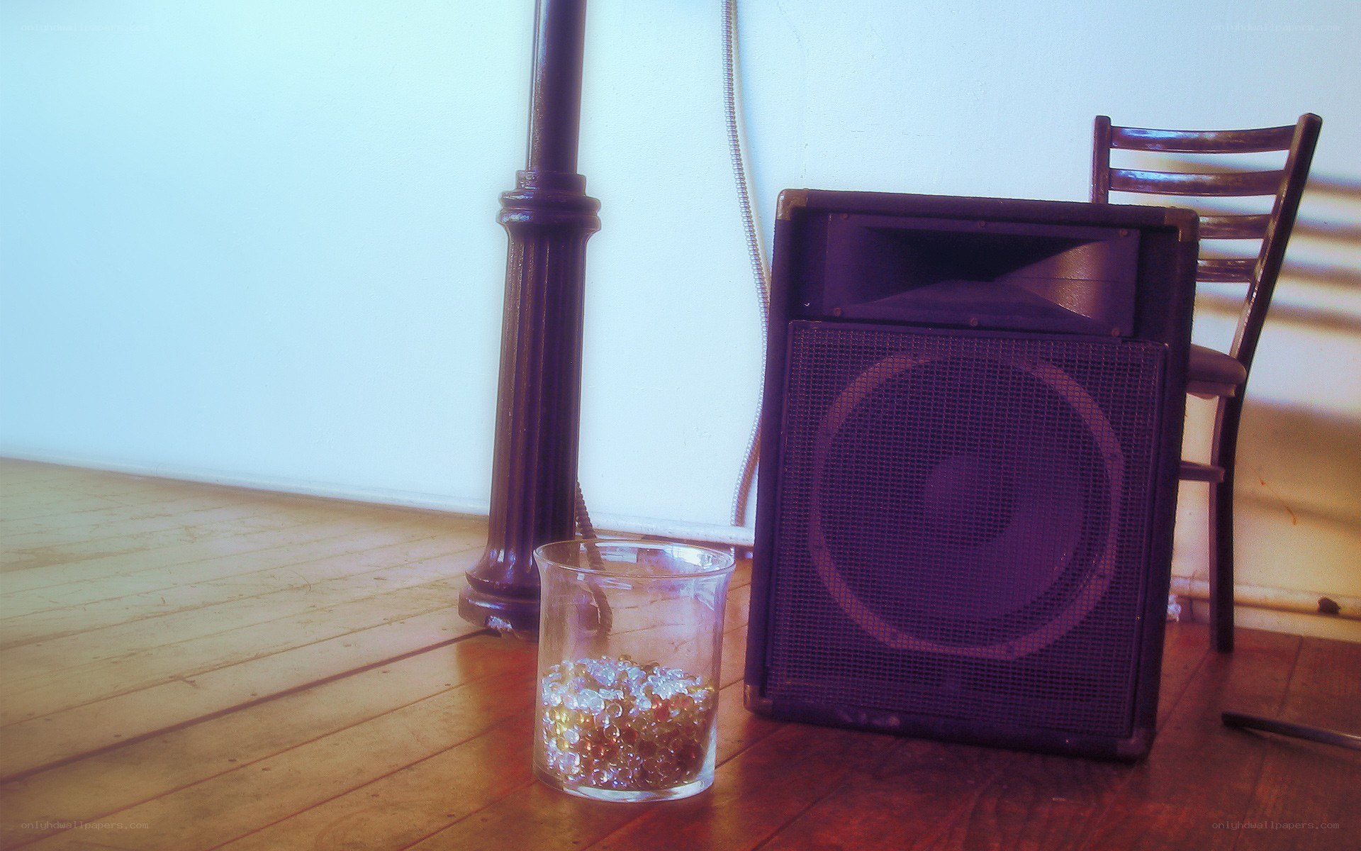 speaker and glass on floor